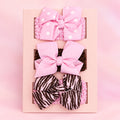 3-pack of baby girl headbands featuring pink polka dot, solid pink, and zebra striped bows