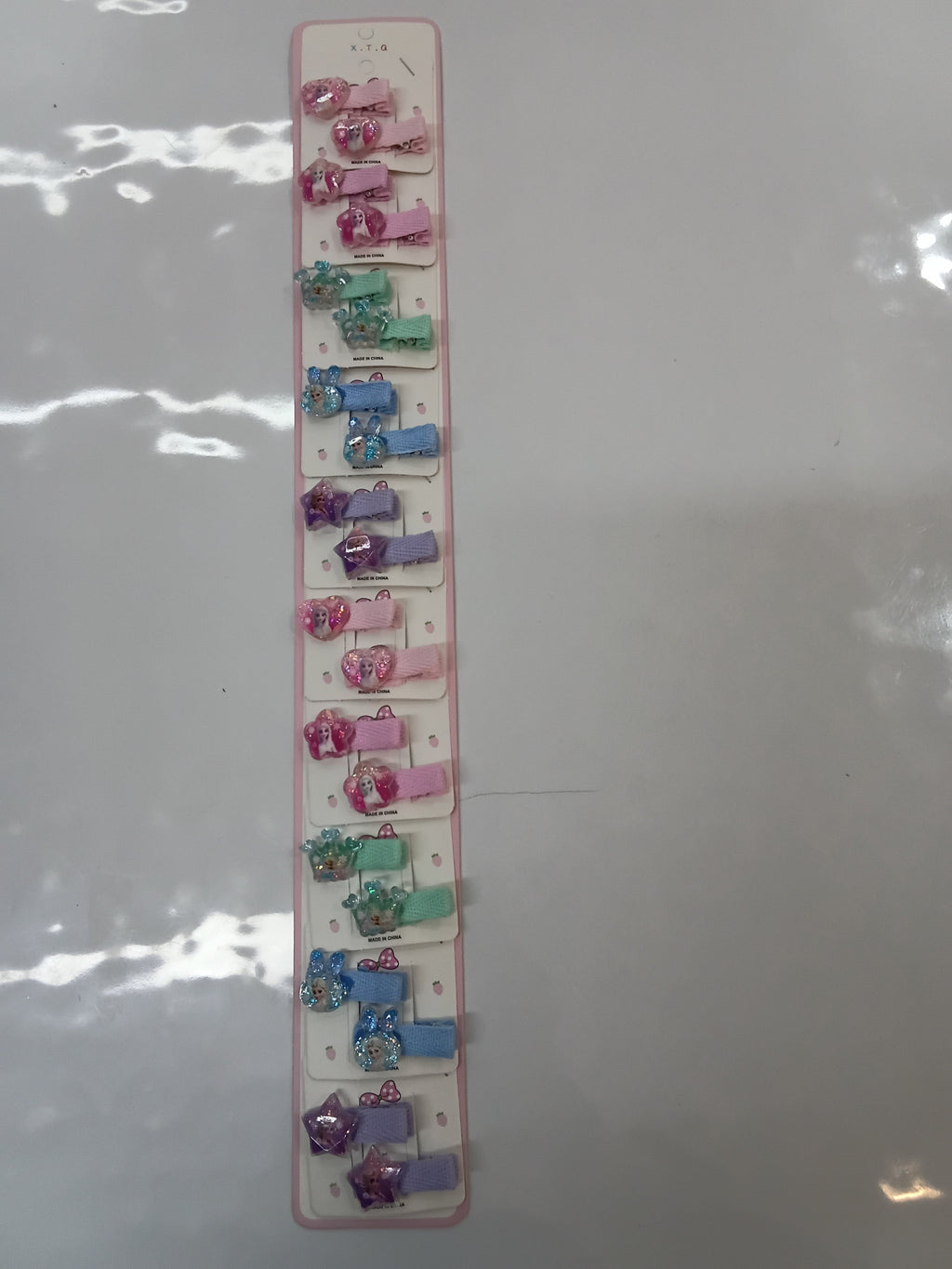 assorted modern snap hair clips for children featuring glittery heart and character embellishments