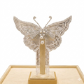 white hair accessory featuring a butterfly design and pearl tassels
