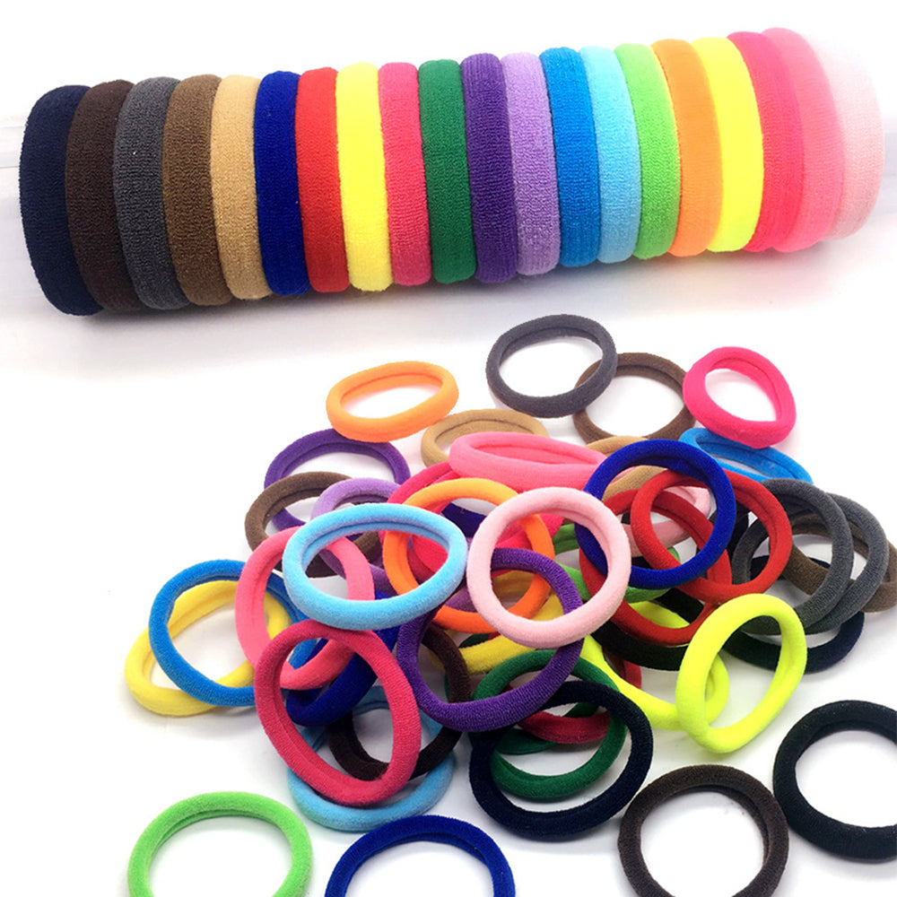 clear plastic tube filled with a rainbow-colored set of soft elastic hair ties.