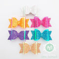 children's accessories featuring glittery bows and ruffled textures